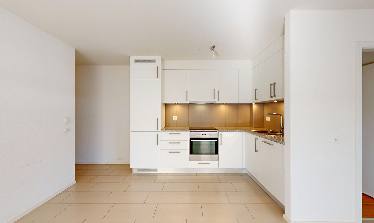 kitchen with stainless steel oven, white cabinets, light tile patterned floors, modern cabinets, and high end white fridge
