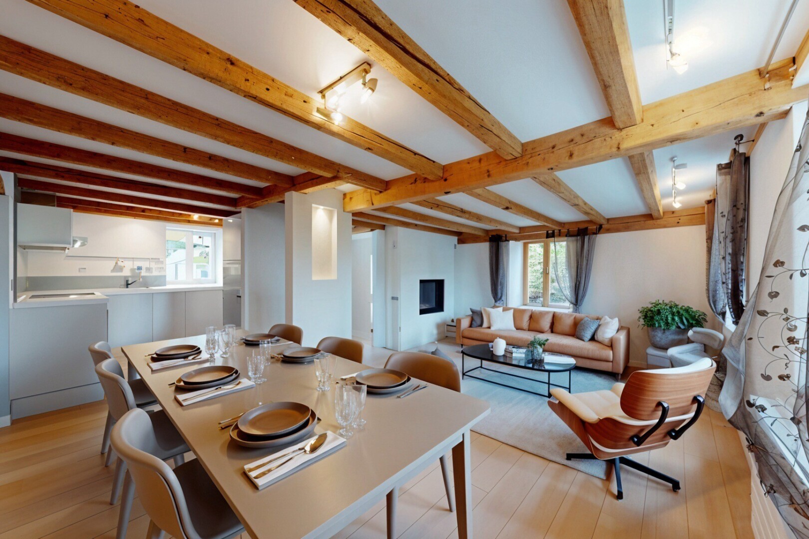 living / dining room with light wood-type flooring, beamed ceiling, and plenty of natural light