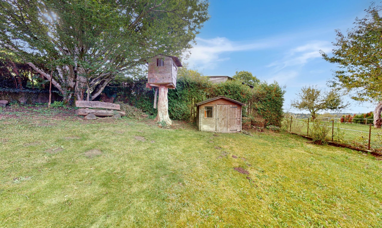 garden featuring a storage unit and a lawn
