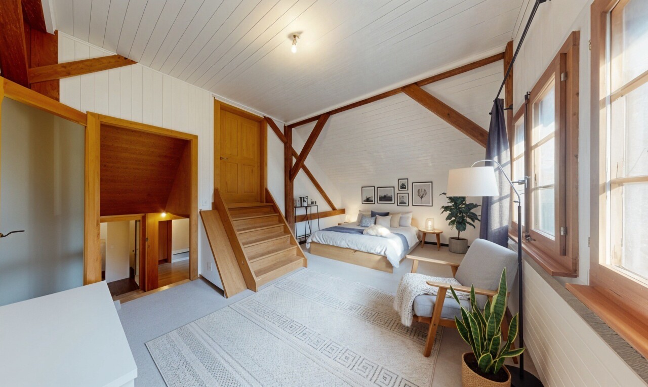 room with lofted ceiling and wooden walls
