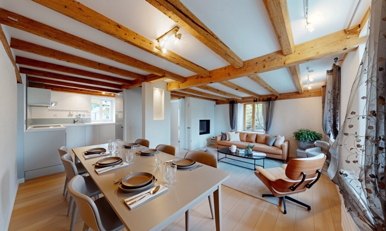 living / dining room with light wood-type flooring, beamed ceiling, and plenty of natural light