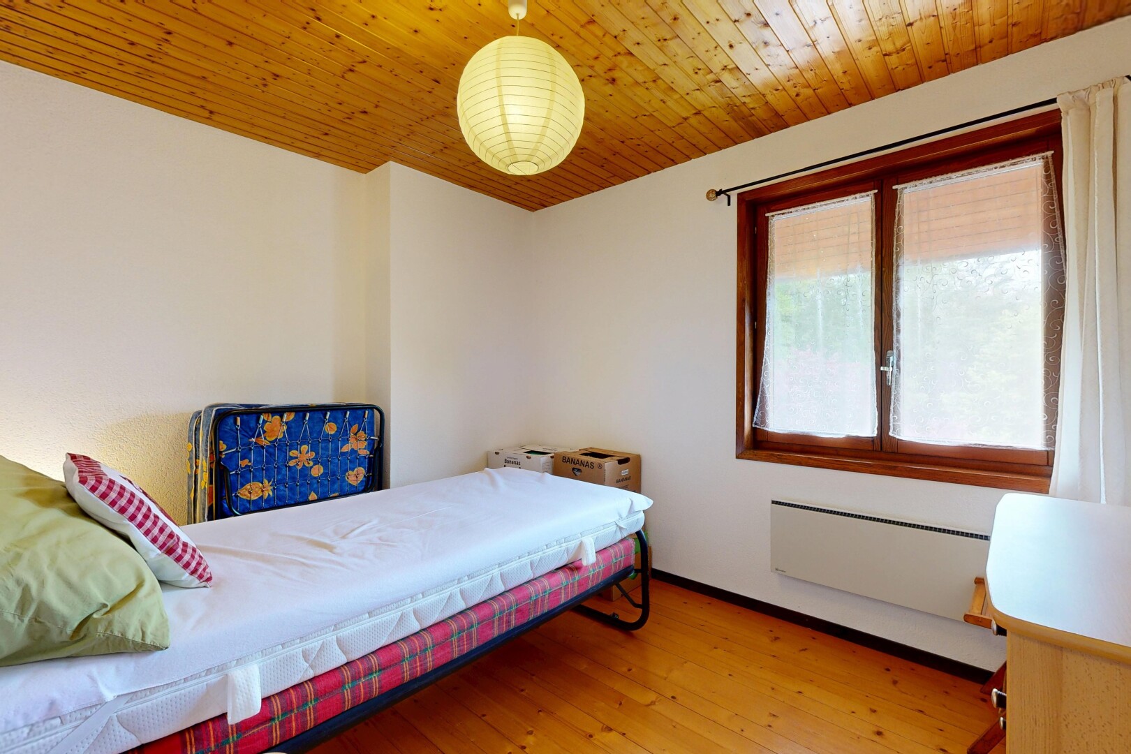 room with light wood finished floors, wooden ceiling, and radiator