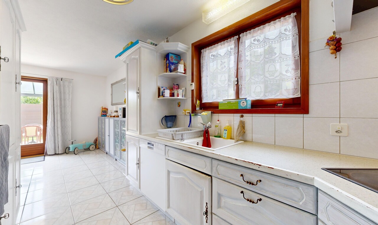 kitchen with white cabinetry, decorative backsplash, and light tile patterned floors