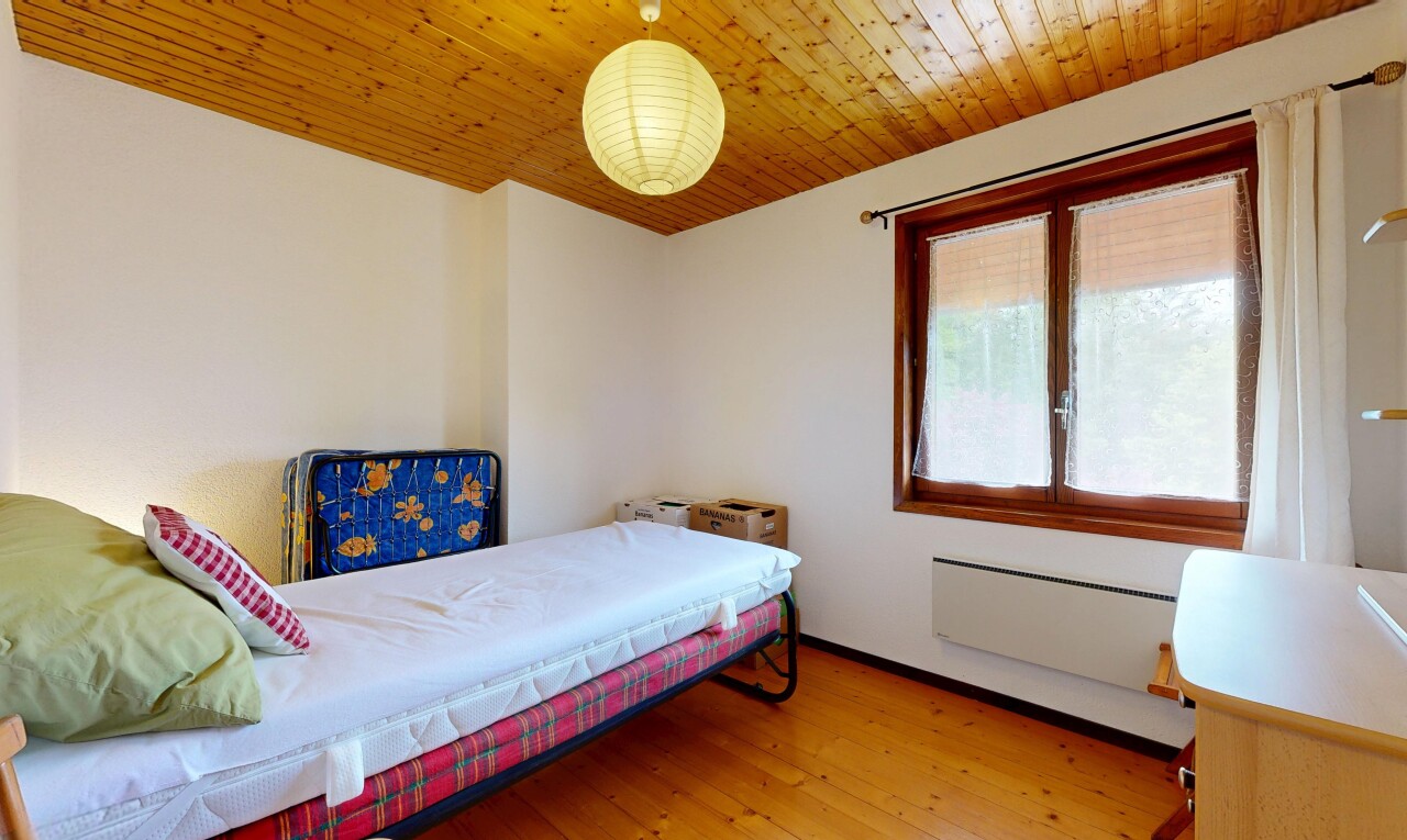 room with light wood finished floors, wooden ceiling, and radiator
