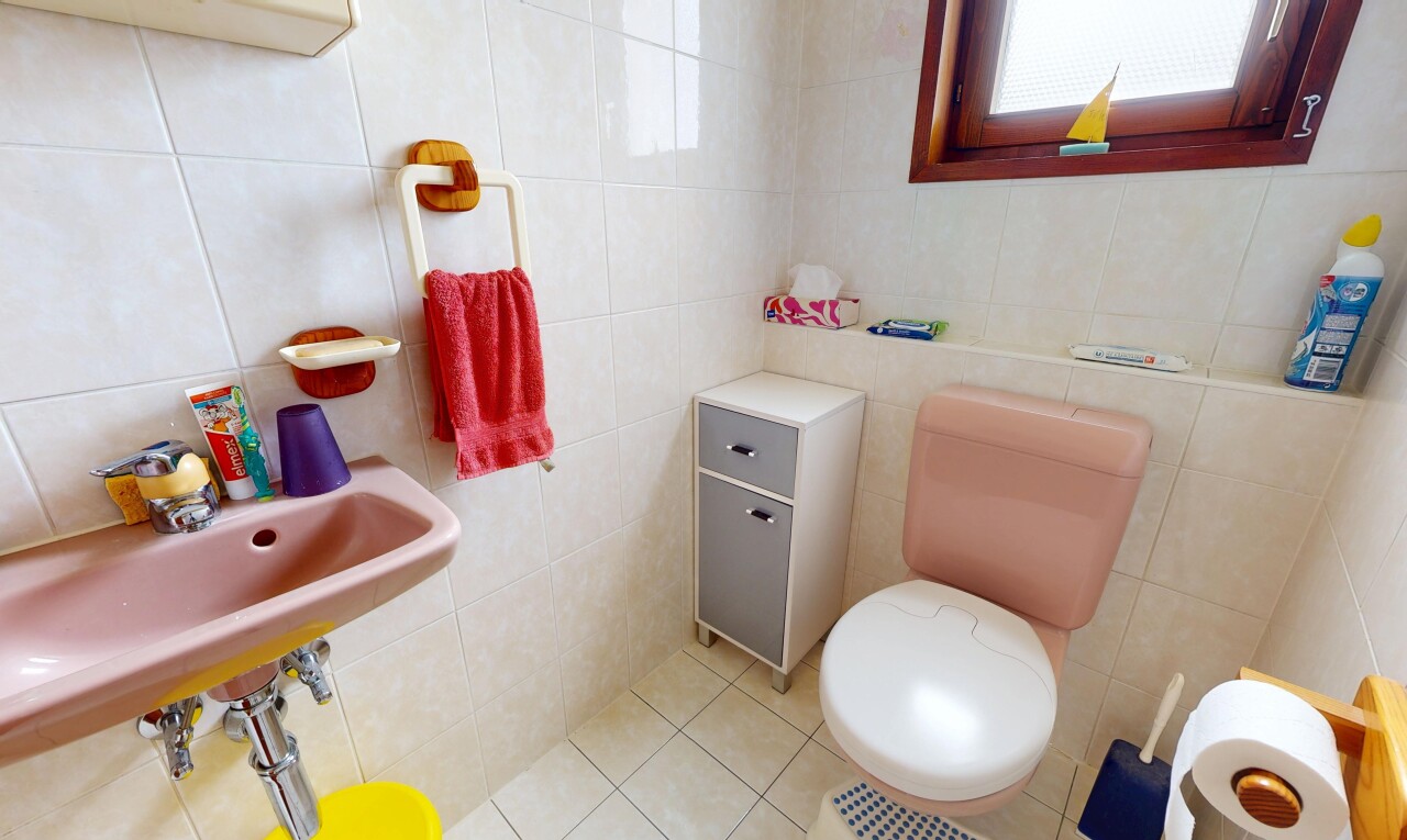 half bathroom featuring tile walls and light tile patterned floors