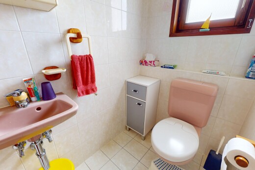 half bathroom featuring tile walls and light tile patterned floors