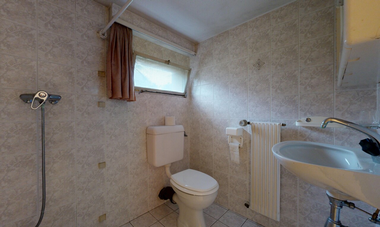 salle de bains avec tile floor, sol en carrelage, radiateur, toilette, et natural light