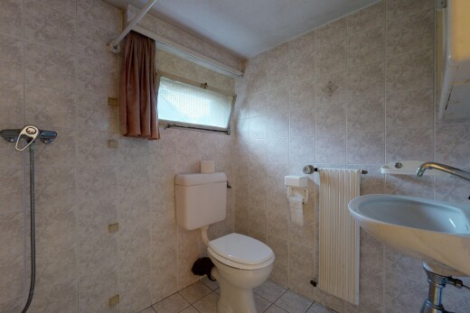 bathroom featuring tile patterned flooring, radiator heating unit, and tile walls