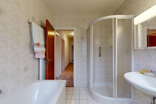 bathroom with tile walls, a shower stall, light tile patterned floors, and a garden tub
