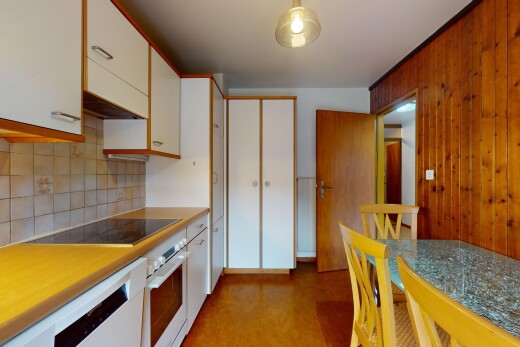 kitchen featuring black electric stovetop, decorative backsplash, white cabinets, and white oven