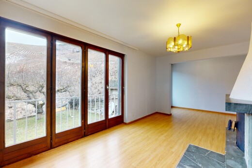 spare room with hardwood / wood-style flooring and a notable chandelier