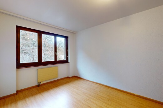 empty room featuring radiator and hardwood / wood-style floors