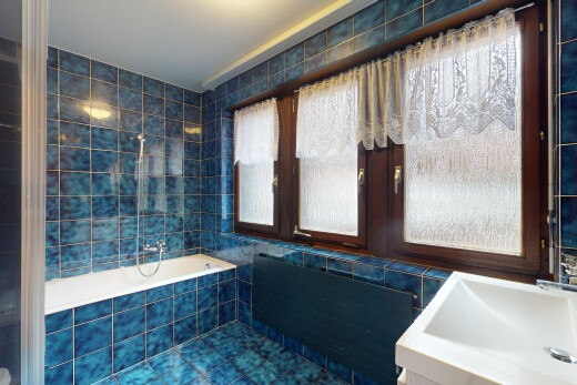 bathroom with tile patterned flooring, sink, and tile walls