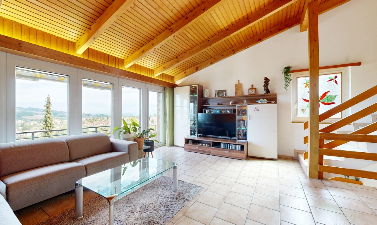 living area featuring a high wooden beamed ceiling and healthy amount of natural light