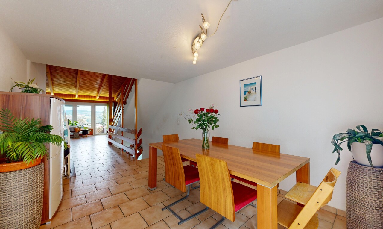dining room with track lighting and stairs