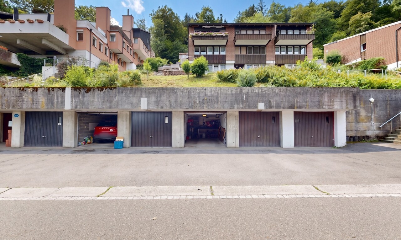 view of building exterior featuring community garages