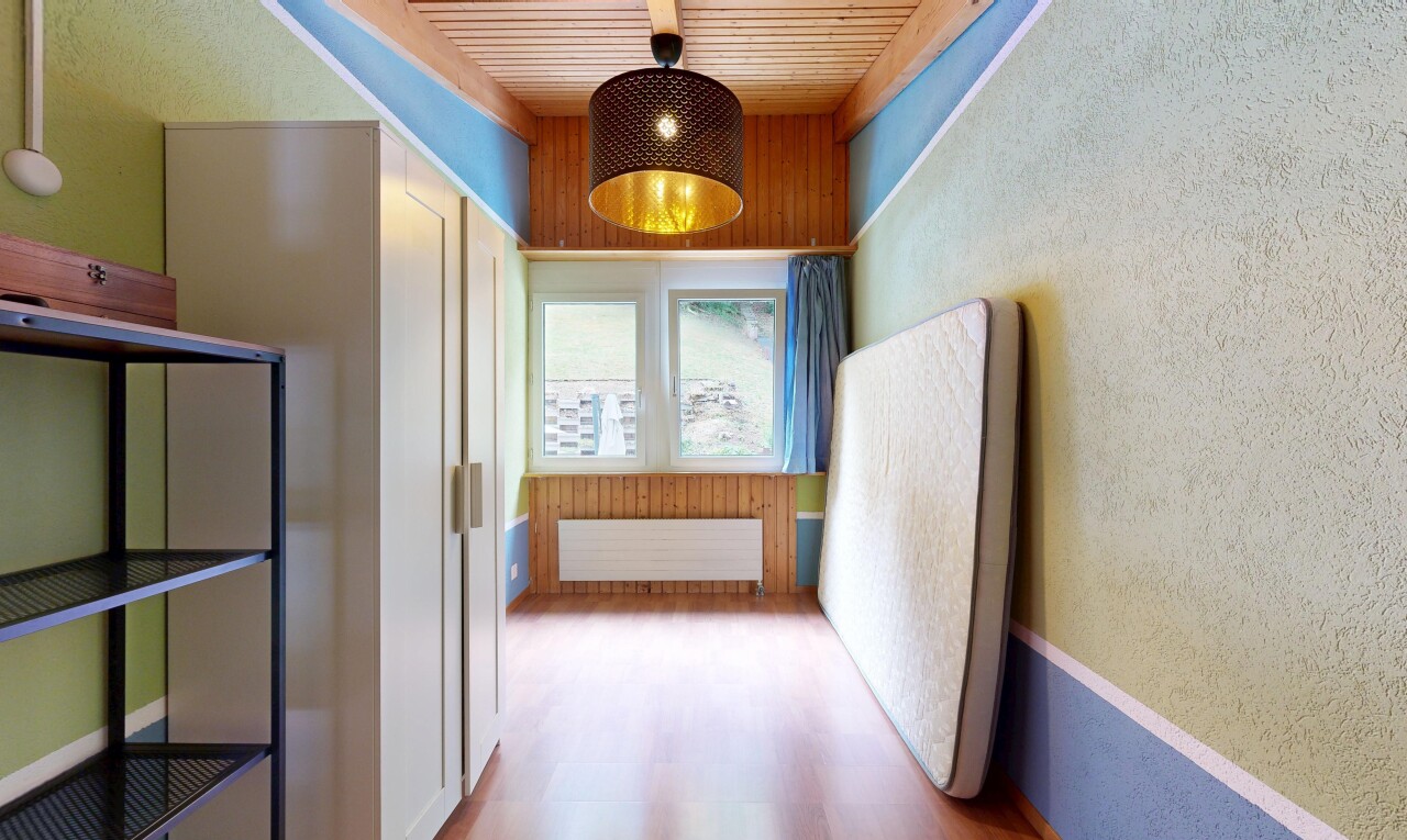 corridor with pendant lighting, radiator, light wood finished floors, wood ceiling, and a textured wall