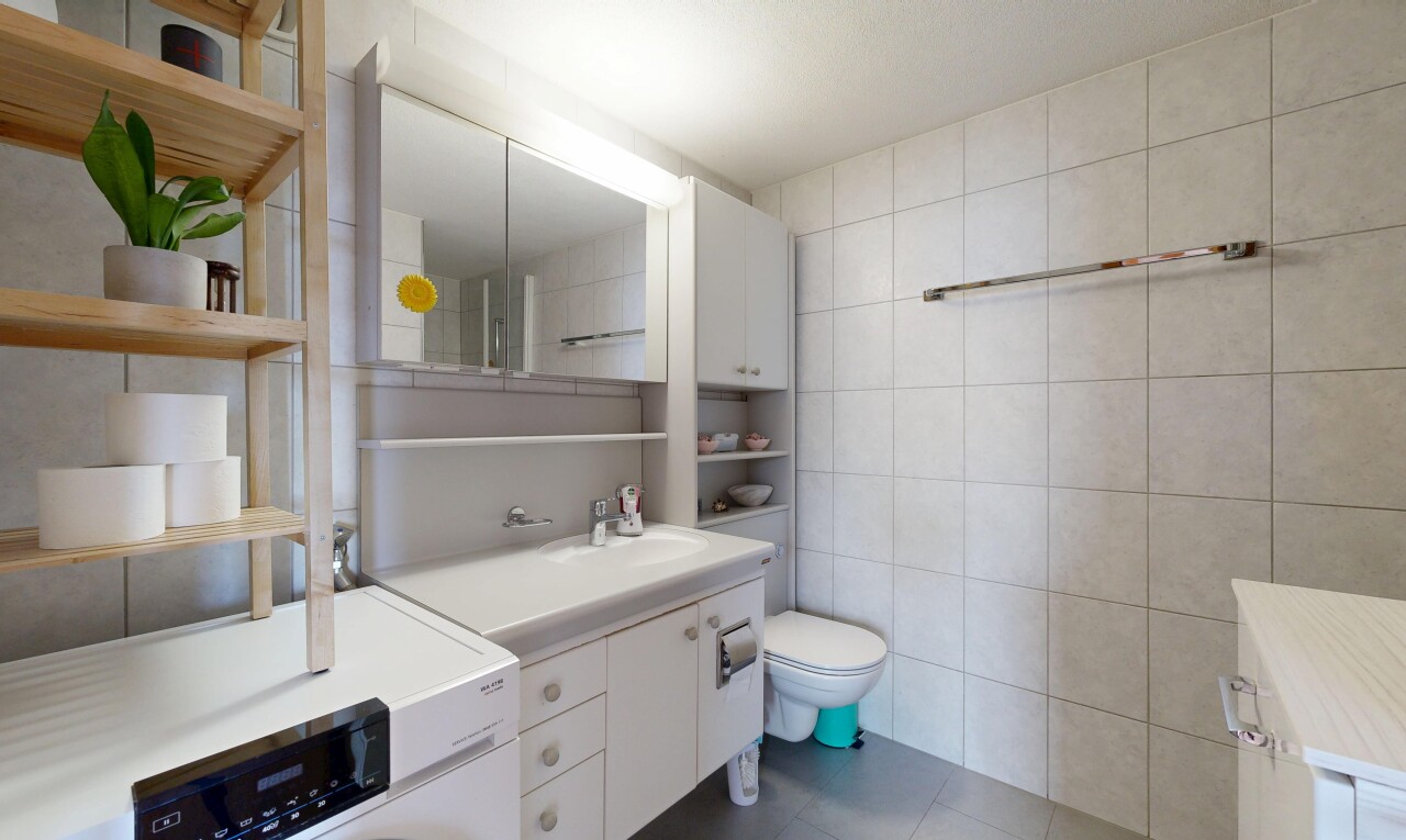 bathroom with tile walls, vanity, and dark tile patterned floors