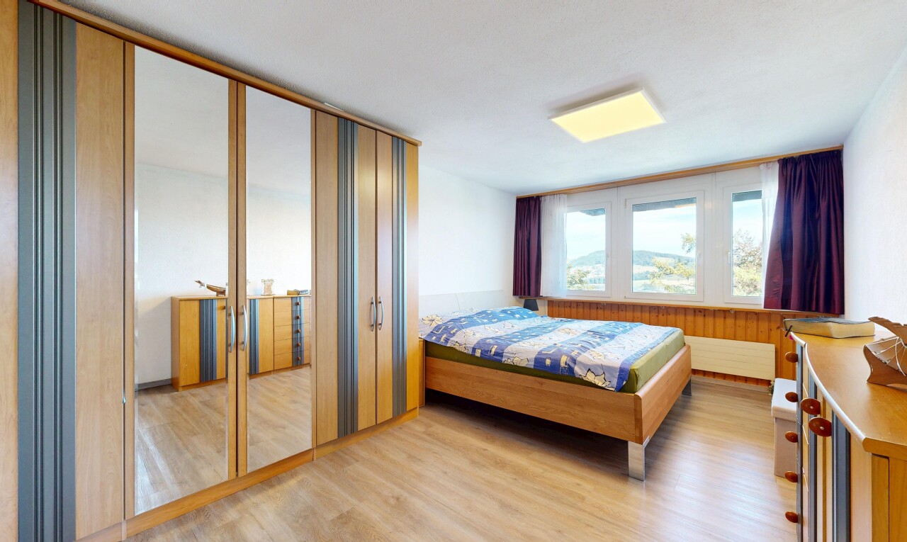 room with light wood-type flooring and a closet