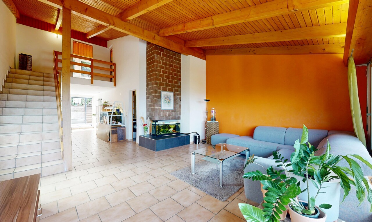 living room featuring a wood ceiling with exposed beams, a fireplace, and light tile patterned floors