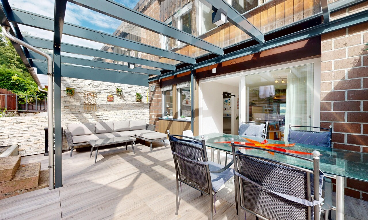 terrace with an outdoor living / dining area, a pergola, and a patio area