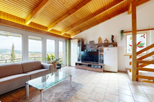 living area featuring a high wooden beamed ceiling and healthy amount of natural light