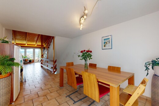 dining room with track lighting and stairs
