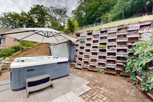 terrace with a hot tub and a patio