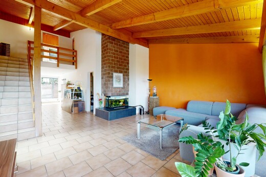 living room featuring a wood ceiling with exposed beams, a fireplace, and light tile patterned floors