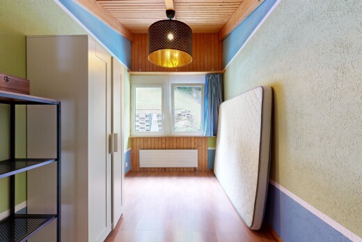 corridor with pendant lighting, radiator, light wood finished floors, wood ceiling, and a textured wall
