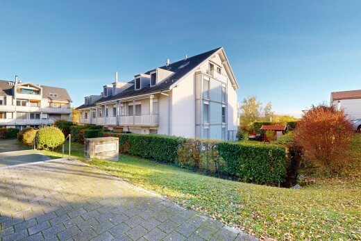 außenansicht mit day time, rasen, dachgaube, property visible, und stuckverkleidung