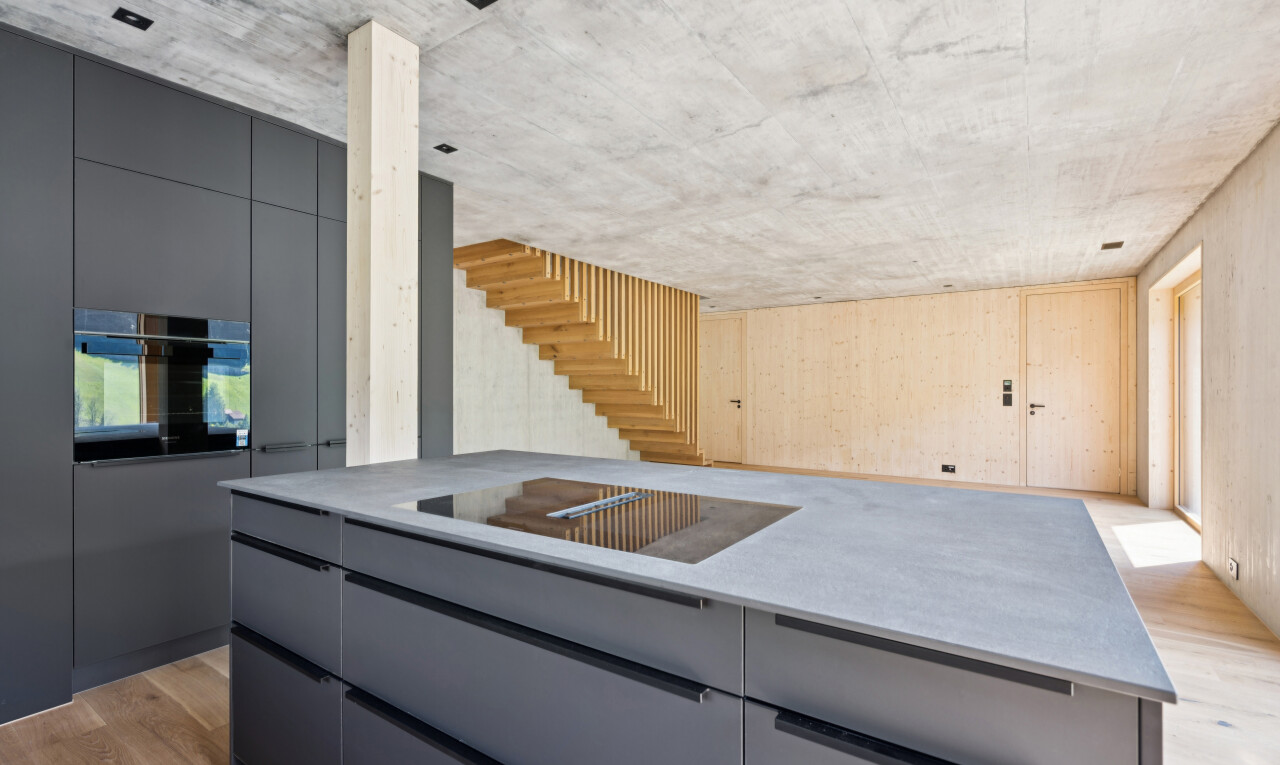 küche mit concrete ceiling, betondecke, flat panel cabinets, schränke mit flachen paneelen, und wood finish floor