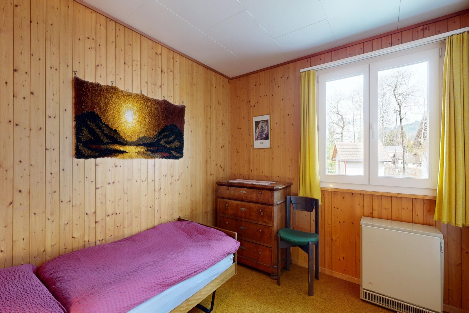 room / bedroom with heating unit, wood walls, and light colored carpet
