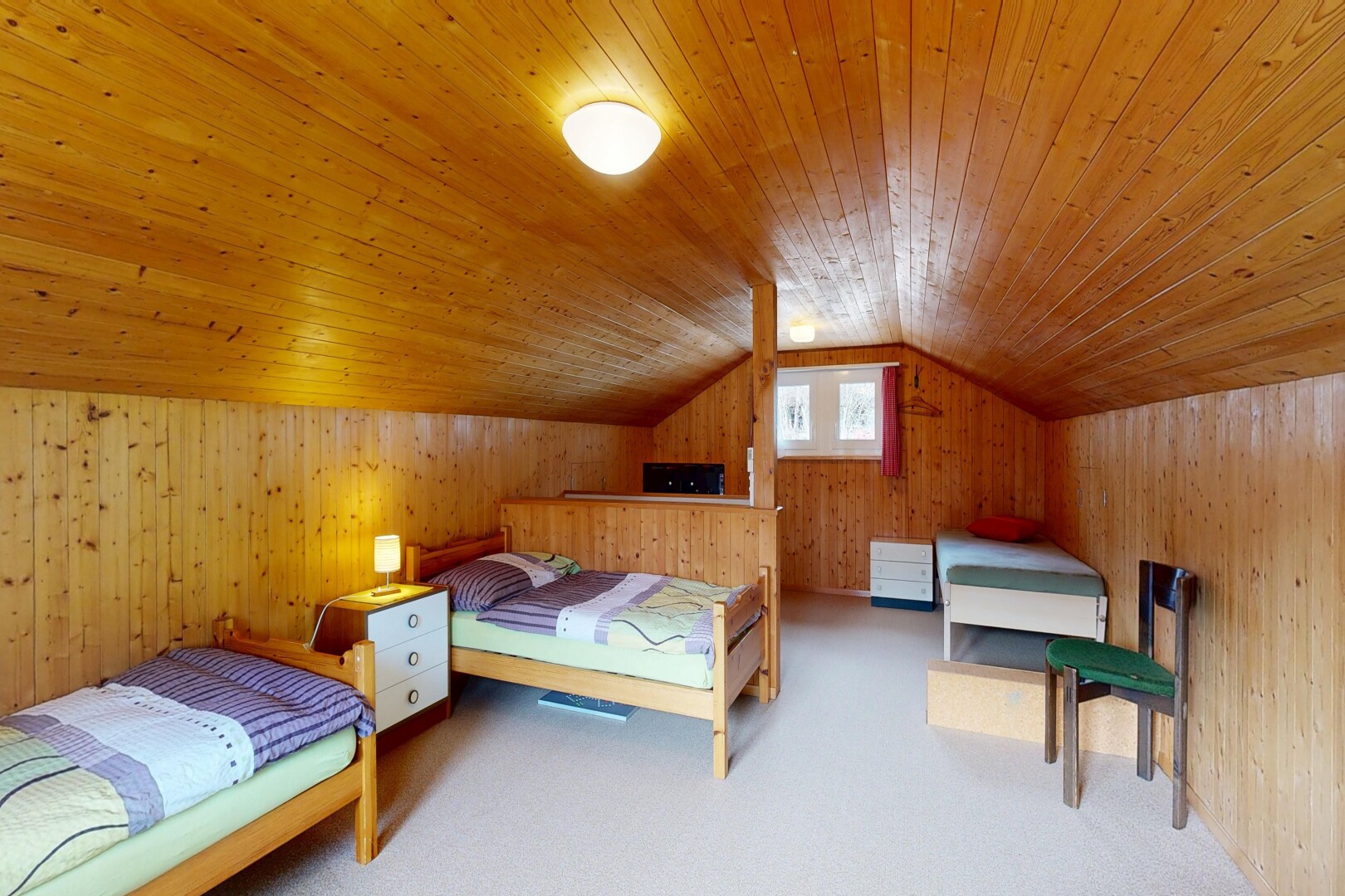 room with wooden walls, carpet flooring, and a vaulted wooden ceiling