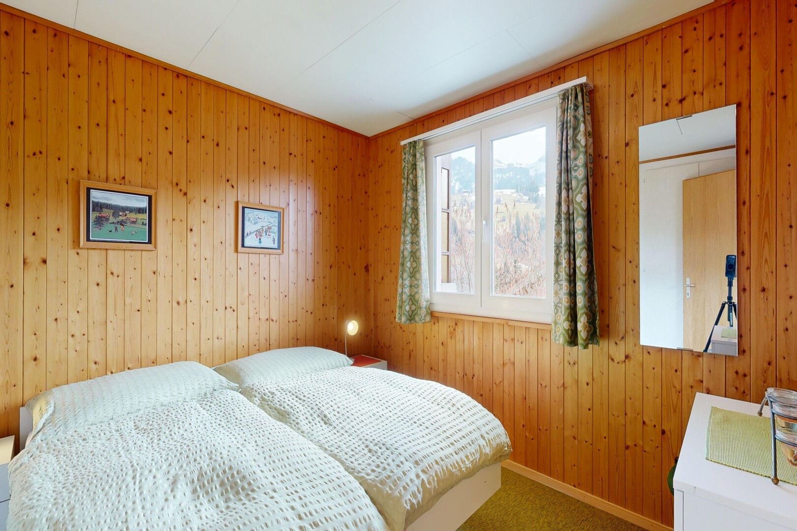 carpeted room featuring wood walls