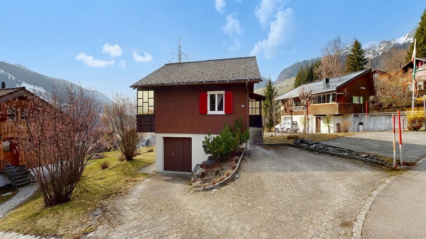 view of home featuring a mountain view, an attached garage, and driveway