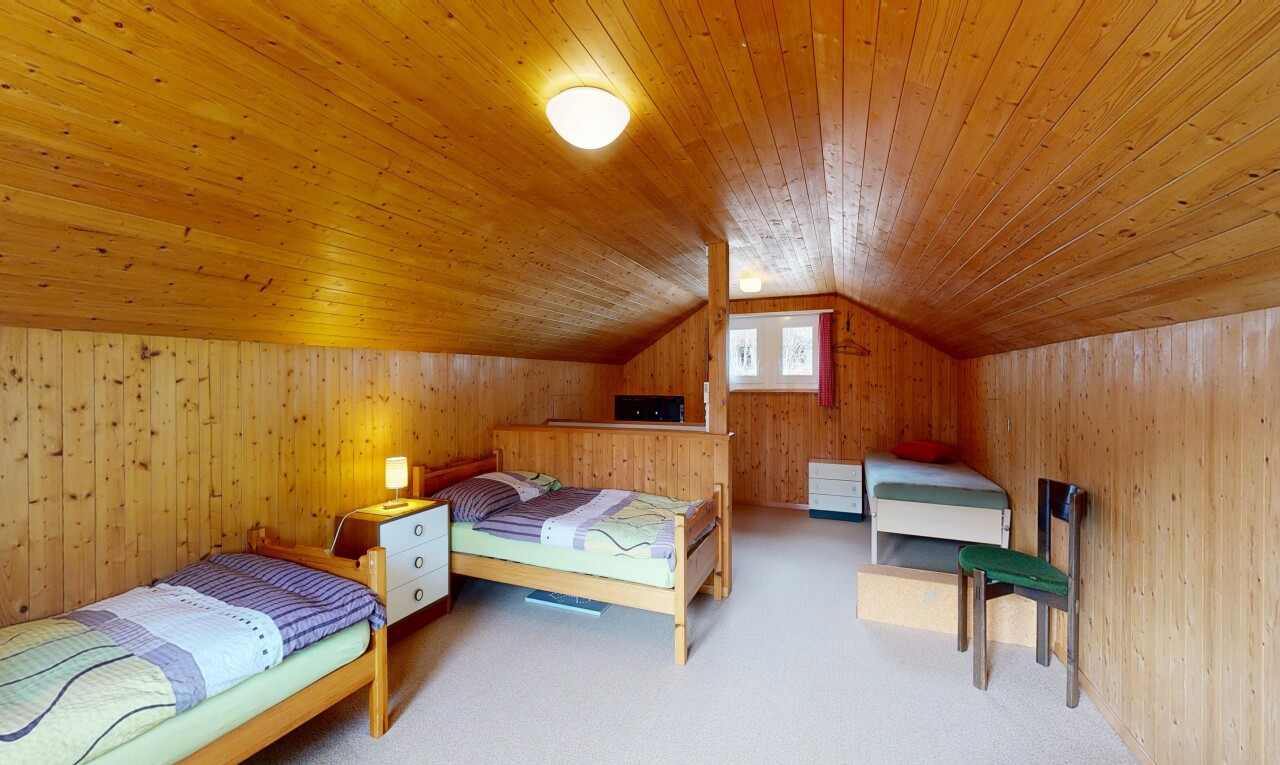 room with wooden walls, carpet flooring, and a vaulted wooden ceiling