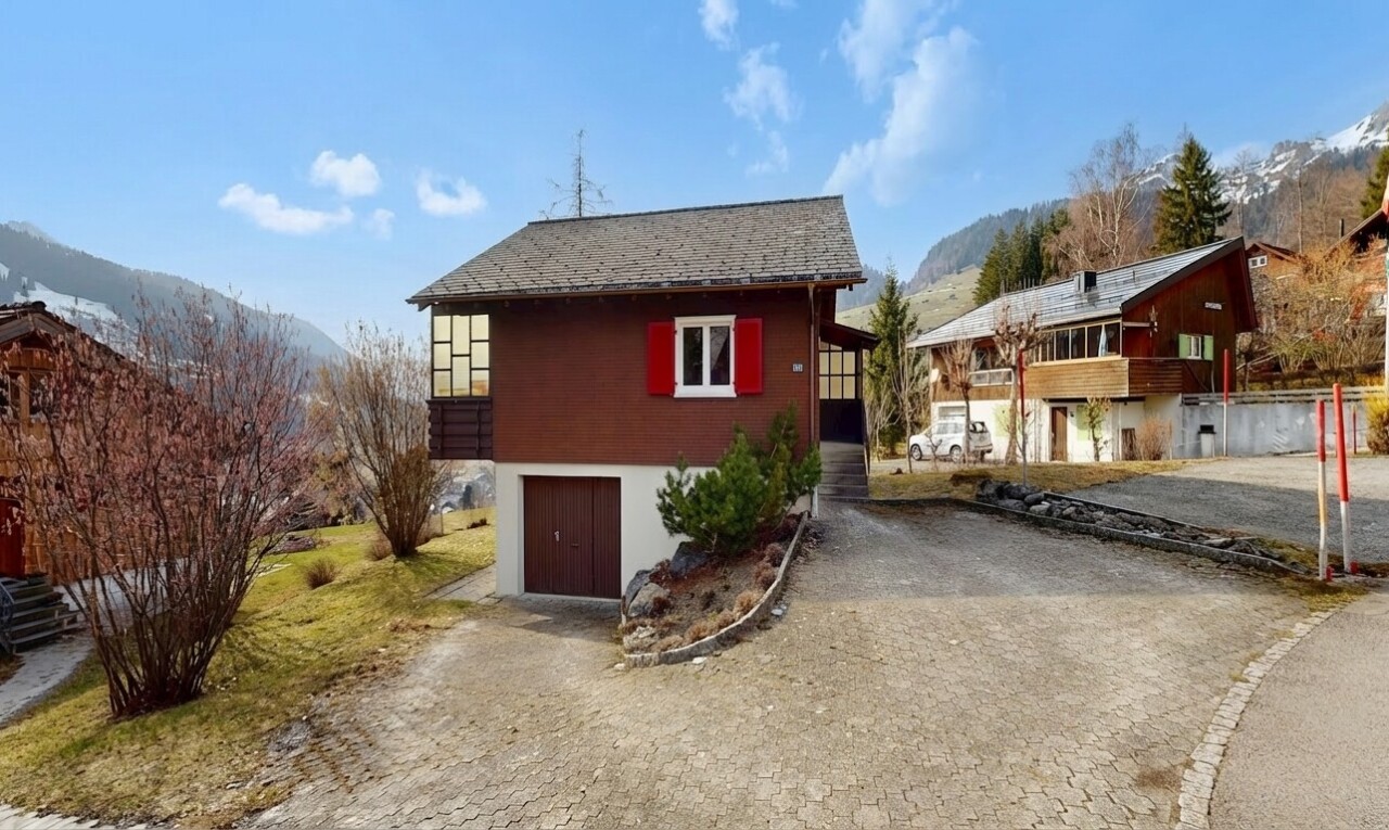 view of home featuring a mountain view, an attached garage, and driveway