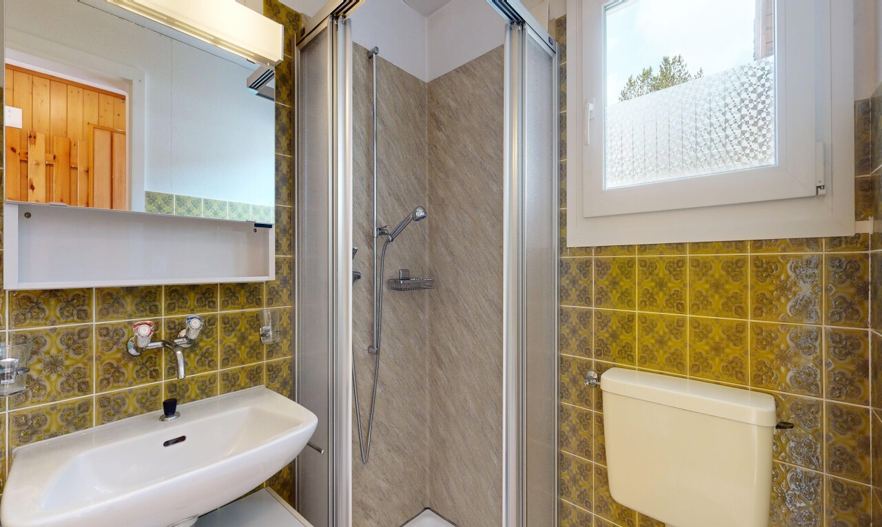 full bathroom featuring tile walls and a shower stall