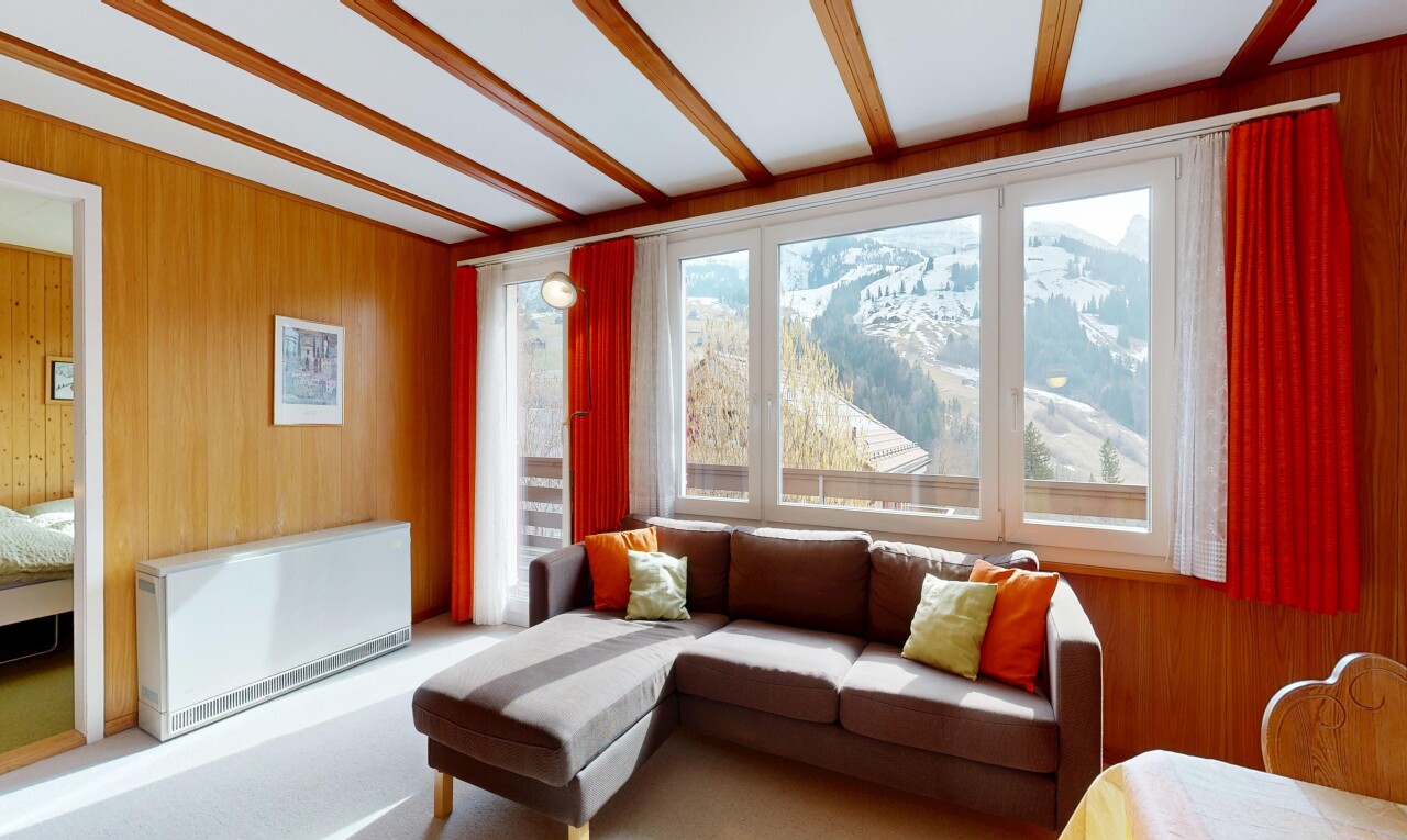 living area featuring wooden walls, heating unit, and radiator heating unit