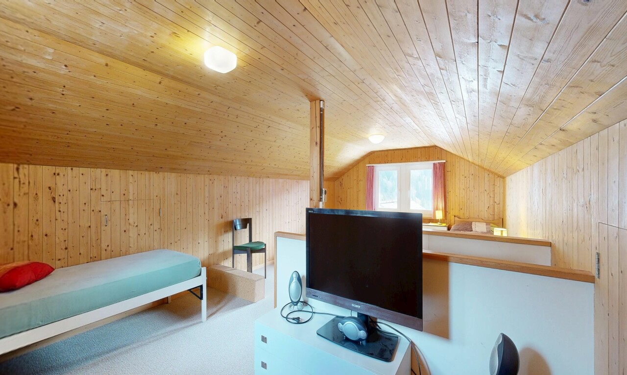 room / bedroom with wooden walls, a vaulted wood ceiling, and an office area