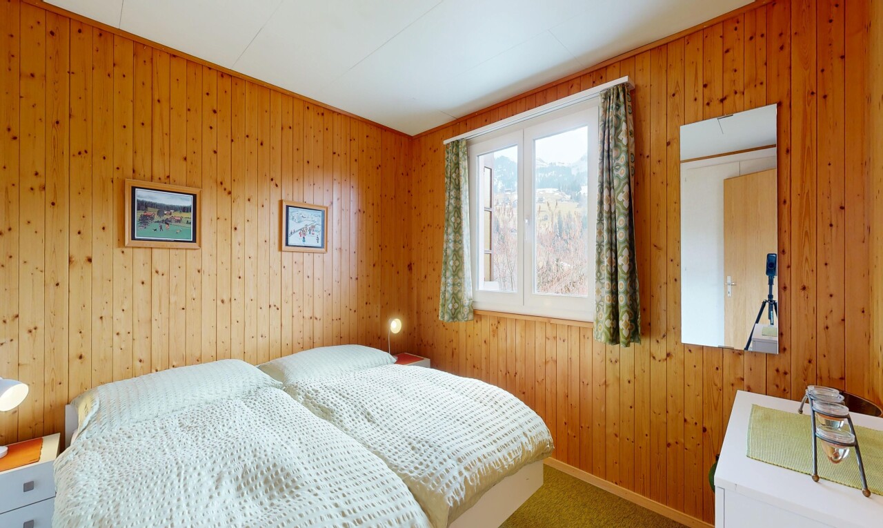 carpeted room featuring wood walls