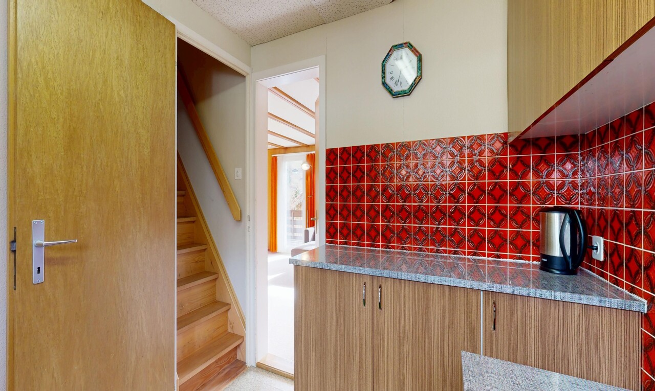 kitchen with dark stone counters and decorative backsplash