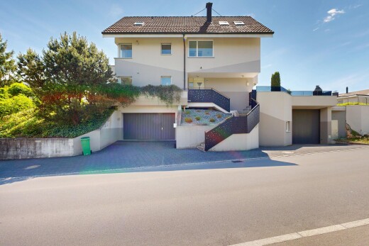 außenansicht mit day time, property visible, stuckverkleidung, und eingebaute garage