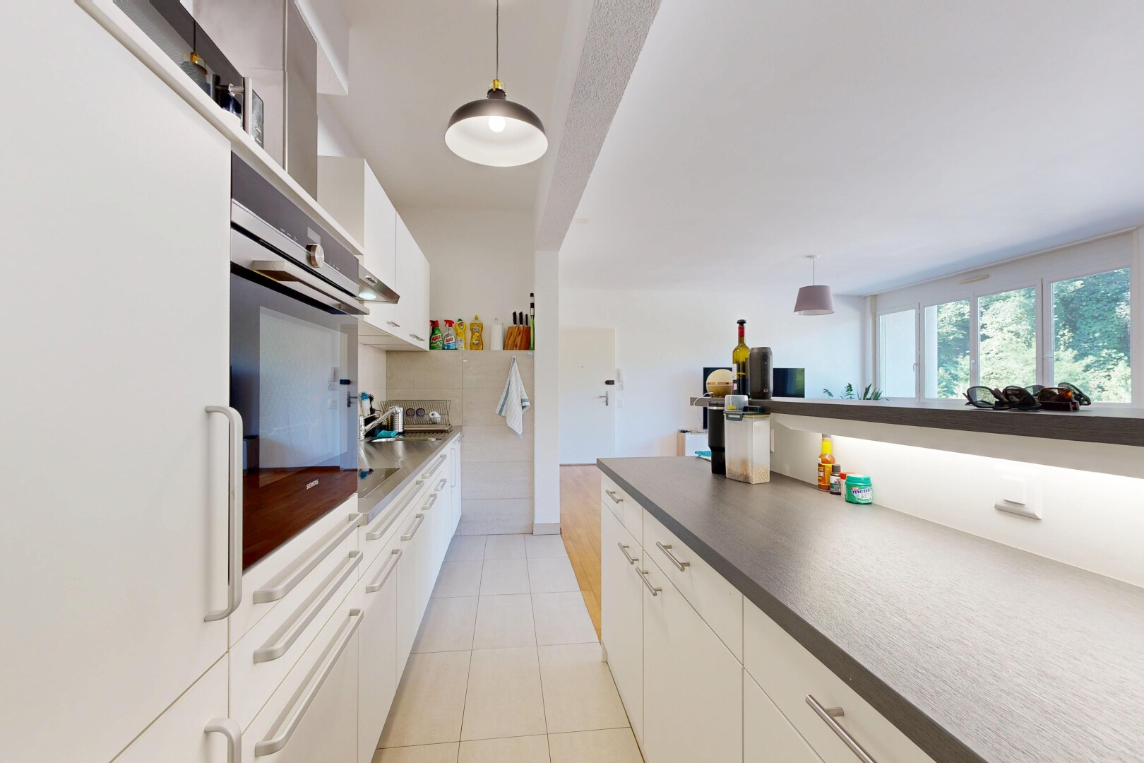 kitchen featuring white cabinetry, white refrigerator, decorative light fixtures, stainless steel oven, and dark countertops
