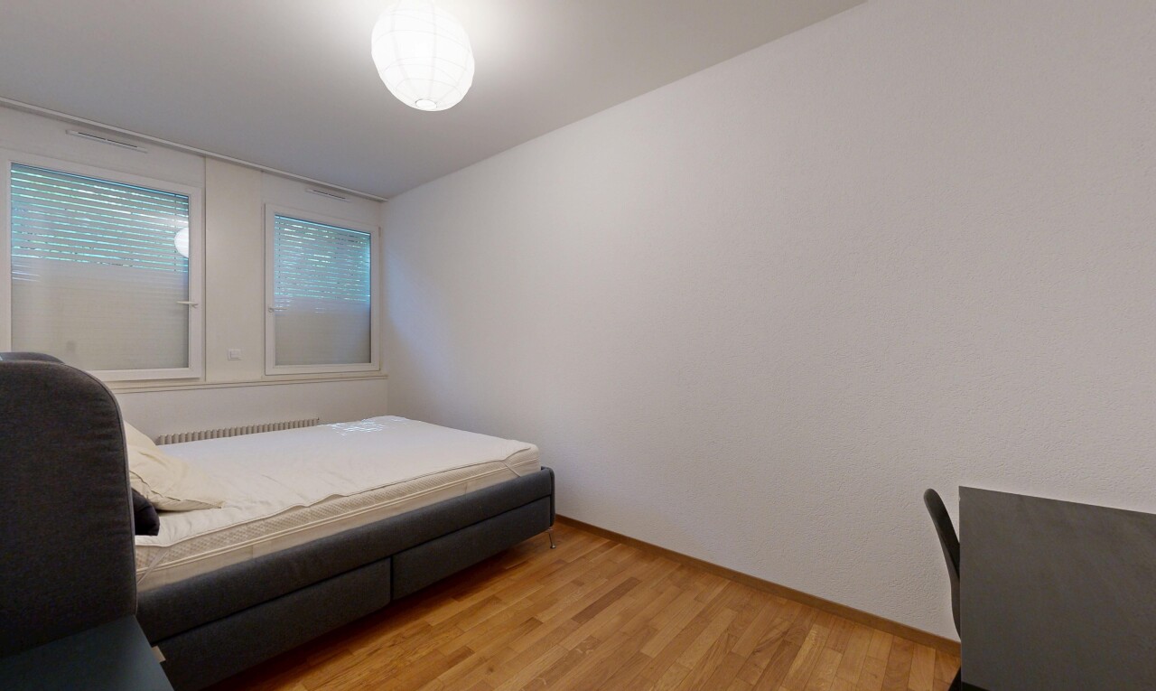 room / bedroom with light wood finished floors and radiator