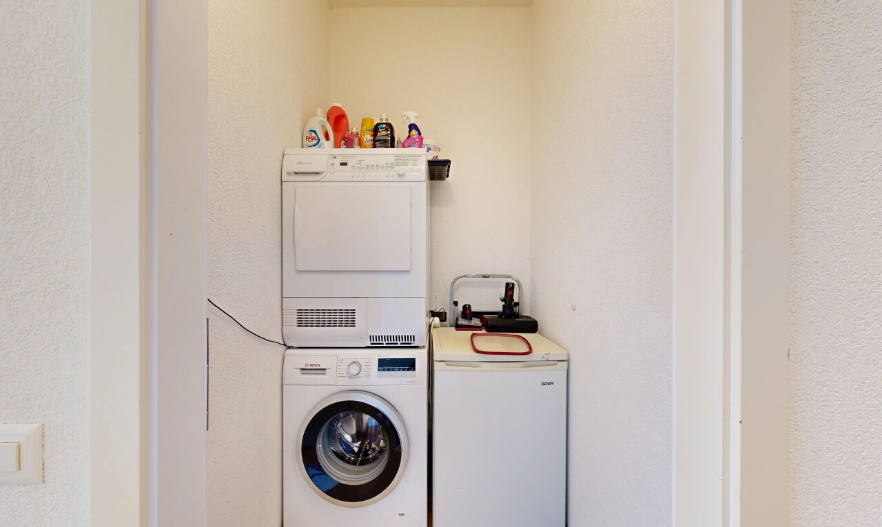laundry room featuring stacked washer / dryer