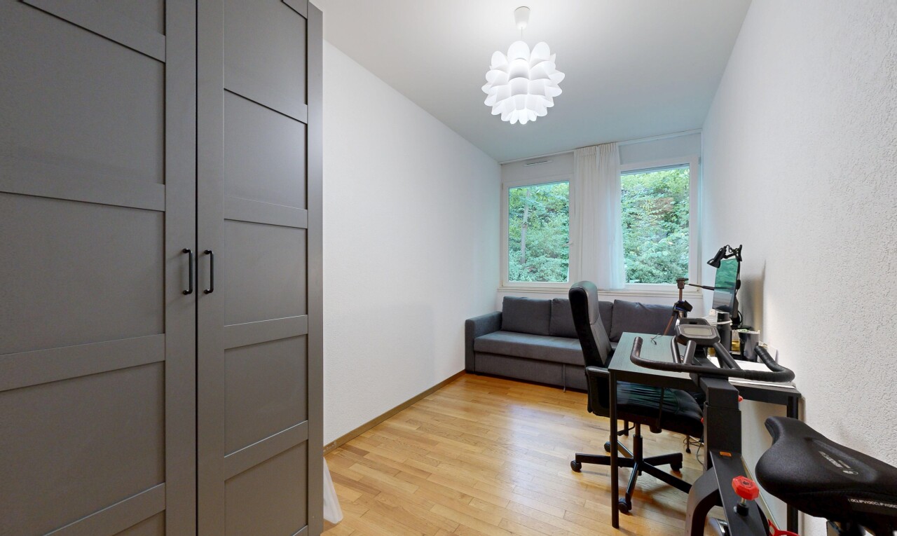 office area with light wood-style flooring and hanging lights