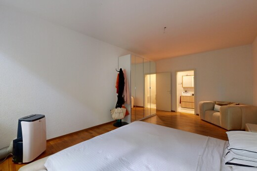 room / bedroom with wood finished floors and ensuite bathroom