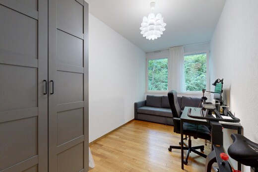 office area with light wood-style flooring and hanging lights